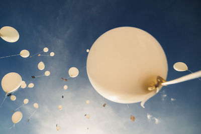 Low angle view of balloons against sky