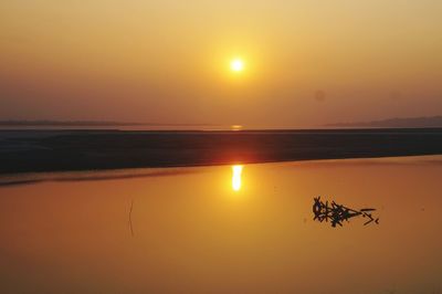 Scenic view of sea against sky at sunset