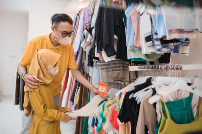 Side view of female friends standing in store