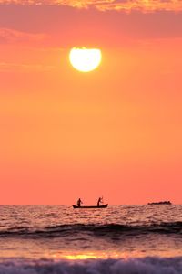 Silhouette people in boat on sea against sky during sunset