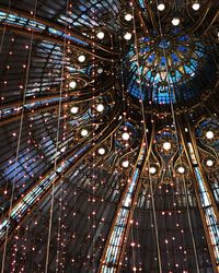 Low angle view of illuminated ferris wheel in building