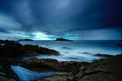 Scenic view of sea against cloudy sky