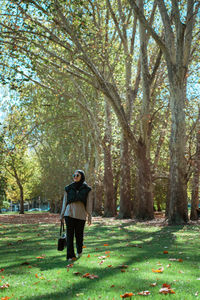 Rear view of woman walking in park