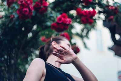 Close-up of woman with flowers on tree