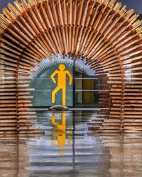 Reflection of yellow umbrella on water