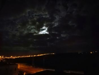 Illuminated cityscape against sky at night