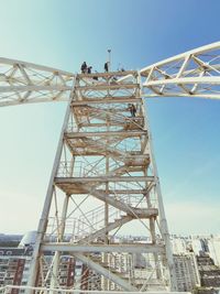 Low angle view of crane against sky