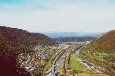 High angle view of road by mountains against sky