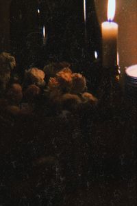 Close-up of lit candles in the dark