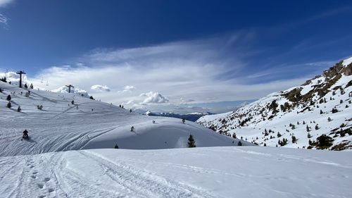 Scenic view of snow covered mountains against sky