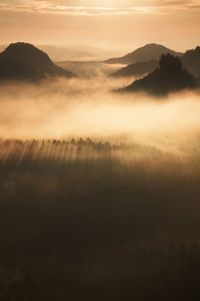 Scenic view of silhouette mountains against sky during sunset