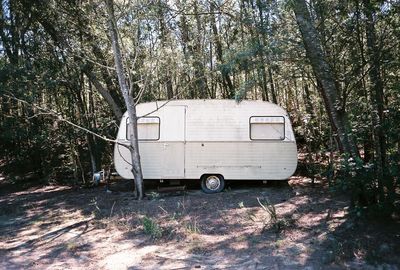 Abandoned caravan in forest
