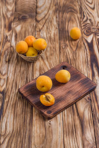 Composition with fresh ripe apricots on wooden background.