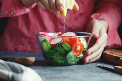 Midsection of woman cooking food at table