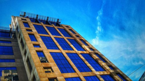 Low angle view of building against blue sky