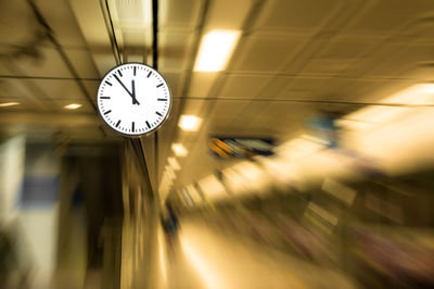 Low angle view of illuminated clock at railroad station