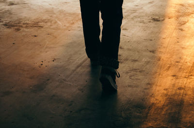 Low section of woman standing on wooden floor