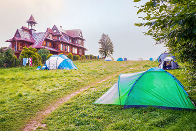 Scenic view of tent on field against sky