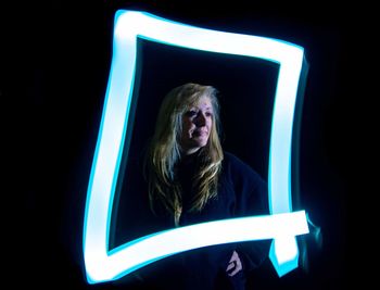 Portrait of woman in black background