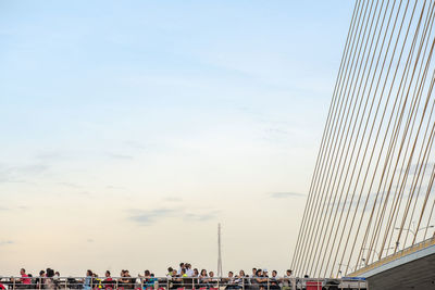 Group of people in city against sky