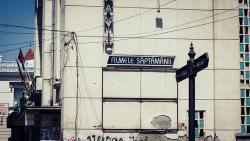 Low angle view of road sign against sky