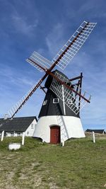 Low angle view of windmill against sky