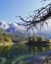 Scenic view of lake by snowcapped mountains against sky