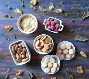 Directly above shot of food amidst leaves on wooden table