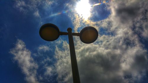 Low angle view of street light against cloudy sky