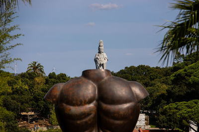 Statue of buddha against trees