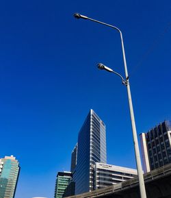 Low angle view of modern buildings against blue sky