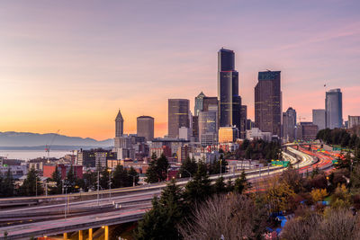 City against sky at sunset