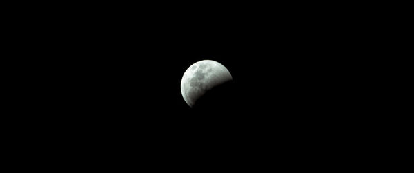 Low angle view of half moon against sky at night