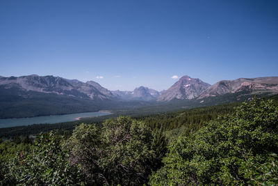 Scenic view of mountains against blue sky