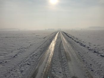 Scenic view of snow covered landscape against sky