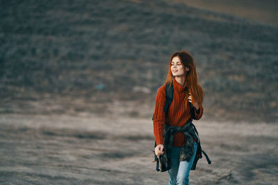 Portrait of smiling young woman standing outdoors