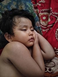 Portrait of cute boy relaxing on bed