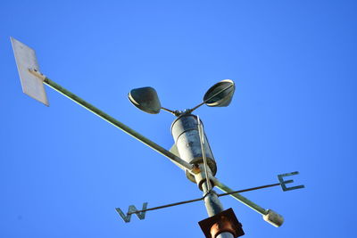 Low angle view of windmill against blue sky