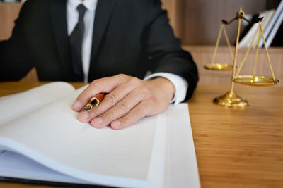 Close-up of hand holding book