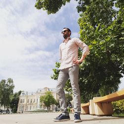 Man standing by tree against sky