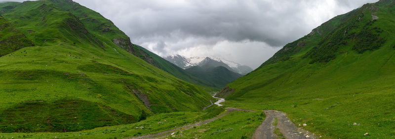 Panoramic view of green landscape against sky