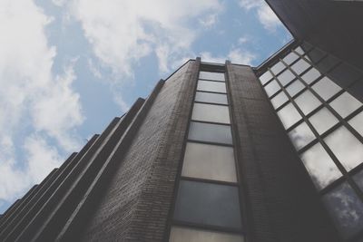 Low angle view of building against cloudy sky