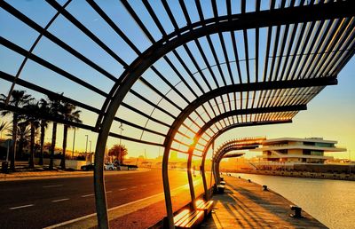 Bridge over river in city against sky