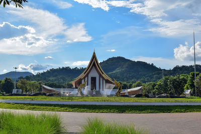 Built structure on field by building against sky