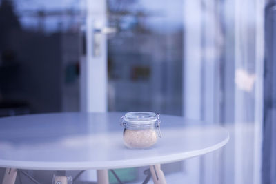 Close-up of sugar in glass jar on table