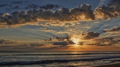 Sunburst through clouds at sunrise