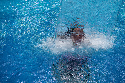 High angle view of man swimming in pool