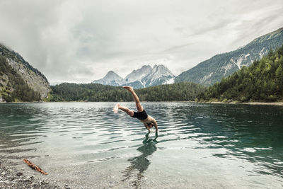 Tourist diving in blindsee lake by mieming range, tirol, austria