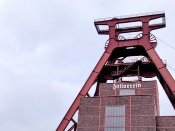 Low angle view of red tower against sky