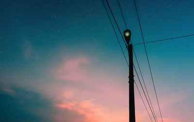 Low angle view of illuminated street light against sky at night